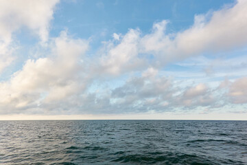 Poster - Panoramic view from the Baltic sea shore after the storm. Clear sunset sky, reflections, still water surface texture. Nature, environment. Idyllic dreamlike seascape