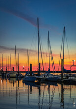 Large Yacht Harbor In Orange Sunset Light, Luxury Summer Cruise, Sailboats In Summer Sunset.