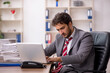 © Elnur - Young male employee unhappy with excessive work in the office