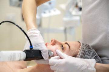 Wall Mural - Beautiful woman getting rejuvenation treatment in beauty salon