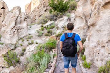 Wall Mural - back of man hiking walking on main loop trail hike in bandelier national monument in new mexico, usa
