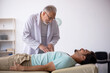 © Elnur - Young male patient visiting old male doctor
