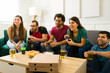 © AntonioDiaz - Friends having a lot of fun while playing video games