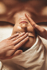 Wall Mural - relaxed female patient receiving massaging face treatment. beauty face. beautiful young girl. body c