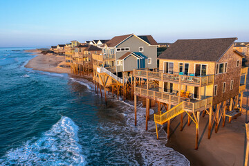 Wall Mural - Aerial view of homes right on the shoreline in the ocean during high tide in Buxton North Carolina Outer Banks