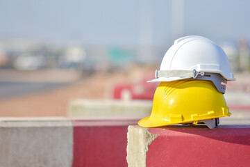 Safety helmet on site construction, hard hat engineer equipment safety first concept