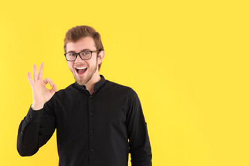 Wall Mural - Concept of people, young man on yellow background