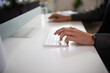 © Austockphoto - Close-up shot of man's hands typing on a keyboard