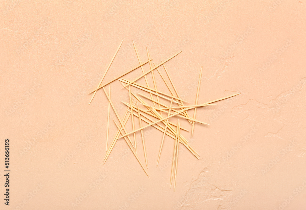 Wooden toothpicks on color background