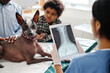 © pressmaster - Unrecognizable doctor standing in front of dog and its owners holding digital tablet with X-ray image on screen