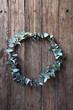 © Austockphoto - Silver Eucalyptus Leaf Wreath lying on wooden planks