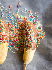 Wall Mural - banana with chocolate and sprinkles close up