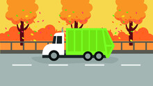 Garbage Truck Rides On The Road Among Autumn Trees