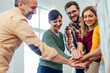 © bnenin - Close up of smiling people, working as a team, cheering themselves, holding hands in the middle.