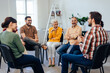 © bnenin - All aged people, sitting in a circle, having a group therapy about mental health.