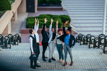 Excited group of entrepreneurs celebrating in street