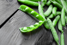 Opened Pea Pods - Beans Can Be Seen. Green Peas On A Wooden Table. Textured Wood And Green Peas In Pods.