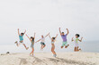 © deagreez - Full length photo of energetic carefree people have good mood jumping sand beach enjoy hang out outdoors
