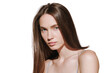 Portrait of beautiful young woman with glossy brown hair posing isolated over white studio background. Hair dying, care