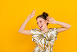 Fototapeta Nowy Jork - Photo of cheerful pretty woman wear print t-shirt smiling dancing isolated yellow color background
