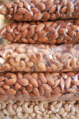 Wall Mural - close up of almond and cashew nuts in a plastic packet 