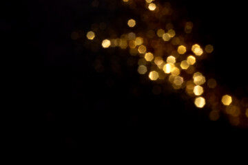 Wall Mural - golden blurred bokeh lights on black background. glitter sparkle stars for celebrate. overlay for yo