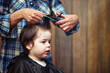 © alexkich - A little boy is trimmed in the hairdresser's
