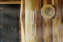 Sand Timer And Thermometer With Hygrometer Hanging On The Wooden Wall Of The Sauna