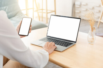 computer screen,cell phone blank mockup.hand woman work using laptop texting mobile.white background for advertising,contact business search information on desk in cafe.marketing,design