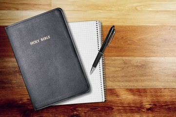 Sticker - Holy bible with note book and pencil on table for christian devotion