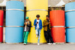 © VISTA by Westend61 - Friends using mobile phones leaning on concrete pipes