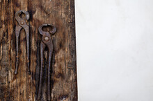 Hand Tools. Old Rusty Pincers, Sheet Of Paper On Dark Wooden Background.