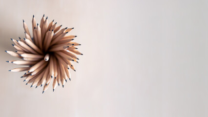 Pencils in pencil holder with space for text area isolated on white background.