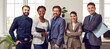 Happy diverse business team standing in the office. Five cheerful confident successful people in smart casual suits smiling and posing for a group photo all together. Banner. Work and success concept