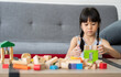 © Prot - Cute Asian little girl playing with colorful toy blocks, Kids play with educational toys at kindergarten or daycare. The creative playing of the kid development concept, Toddler kid in the nursery.