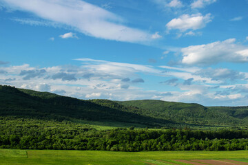 Beautiful blue sky and green mountain landscape in Ukraine. Carpathian mounts as a travel destination. Alpine vacation for summertime