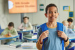 © Seventyfour - Waist up portrait of black young schoolboy with backpack looking at camera while standing in classroom, copy space