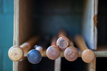 Selective Focus View Of Baseball Bat Ends In A Storage Rack At A Ballpark