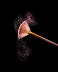 Canvas Print - Make up brush with cosmetic powder splash, over black background. Splash image