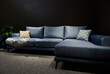 Stylish modern velour blue sofa or sofa bed with cushions in home interior.