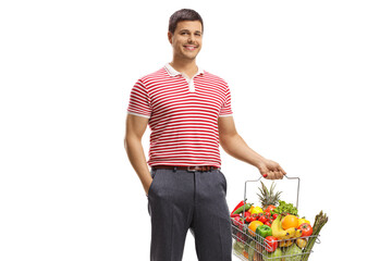 Poster - Man smiling and holding a shopping basket with healthy fruits and vegetables