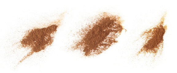 Wall Mural - Set pile cinnamon powder isolated on white, top view