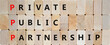 © Dzmitry - PPP private public partnership symbol. Concept words PPP private public partnership on wooden blocks on a beautiful wooden background. Business PPP private public partnership concept. Copy space