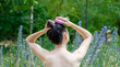 hair growth stimulating, scalp massage.woman in garden,green grass background using  pink scalp massager shampoo brush with silicone,flexible bristels.hair care,head relaxation.
