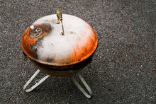 Old Rusty Small Barbeque Cooker In A Garden. Cheap Metal Cooking Device. Worn Out Budget Way To Cook Food.