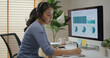 © ChayTee - Asia people young casual woman remote work at desk home phone call talk study learn MBA online class. SEO sale plan report data chart graph on desktop PC screen reskill upskill career job workforce.