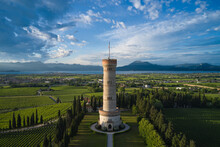 Tower Of San Martino Della Battaglia In The Background Blue Sky, Vineyards, Lake Garda, Italy. Round High Tower Of San Martino Della Battaglia Surrounded By Vineyards Aerial View.