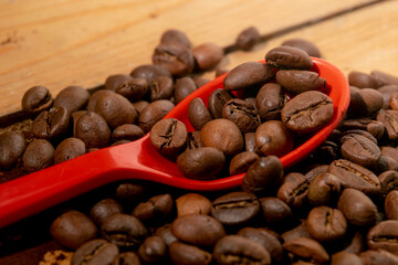 coffee gardens and plastic spoon on wooden board