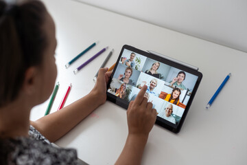 Wall Mural - Closeup view of little girl using tablet for conversation video chat at home