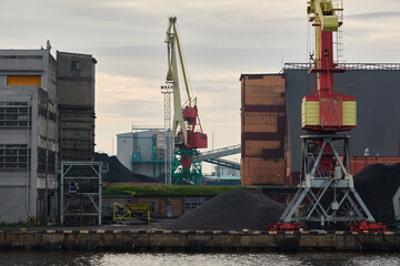 Wall Mural - Cargo port terminal in Ventspils, Latvia. Cranes close-up. Baltic sea. Freight transportation, logistics, global communications, economy, business, industry, supply, special equipment